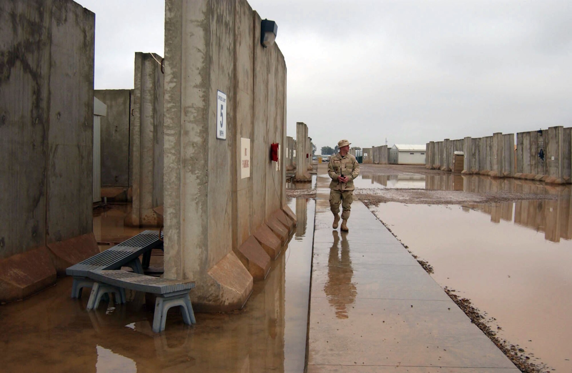 BALAD AIR BASE, Iraq (AFPN) -- Tech. Sgt. Bob Brock surveys water buildup in a housing area here to ensure Airmen are not in danger of slipping and injuring themselves. He is the non-commissioned officer in charge of ground safety with the 332nd Air Expeditionary Wing. (U.S. Air Force photo by Staff Sgt. Tammie Moore)