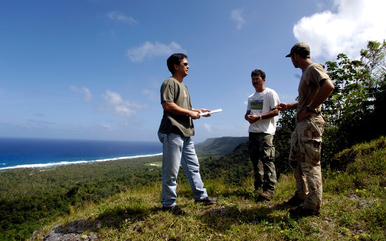 ANDERSEN AIR FORCE BASE, Guam (AFPN) -- Dana Lujan (left), Jeff Quitugua and Chris Jones (right) discuss the endangered Marianas crow. Mr. Lujan is the liaison for the Guam Department of Agriculture, which has a partnership with the base to re-introduce the Marianas crow back to the island. Mr. Lujan is the 36th Expedition Air Wing's chief conservation officer. Mr. Quitugua is a wildlife biologist and Mr. Jones is a wildlife technician from the Guam Department of Agriculture. (U.S. Air Force photo by Tech. Sgt. Shane A. Cuomo)
