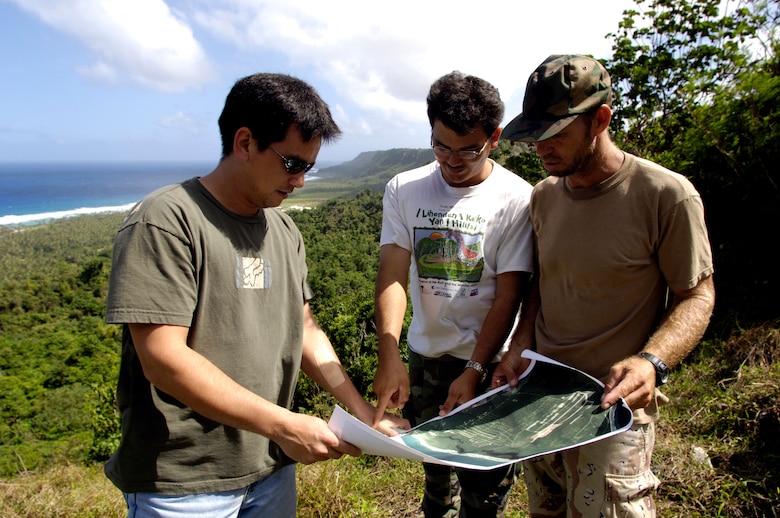 ANDERSEN AIR FORCE BASE, Guam (AFPN) -- Dana Lujan (left), Jeff Quitugua and Chris Jones (right) look over a map of Anderson Air Force Base. Mr. Lujan is the liaison for the Guam Department of Agriculture, which has a partnership with the base to re-introduce the Marianas crow back to the island. Mr. Lujan is the 36th Expedition Air Wing's chief conservation officer. Mr. Quitugua is a wildlife biologist and Mr. Jones is a wildlife technician from the Guam Department of Agriculture. (U.S. Air Force photo by Tech. Sgt. Shane A. Cuomo)