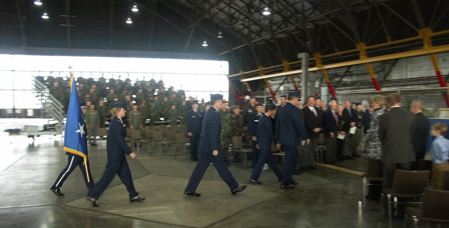 Col. Maryanne Miller, Maj. Gen. Robert Duignan, and Col. Donald Fletcher Jr., walk to the stage during the January weekend.  It marked the end of Col. Fletcher's time at the wing and the continuation of Col. Miller's as she moved from the Operations Group commander to the wing commander position.
