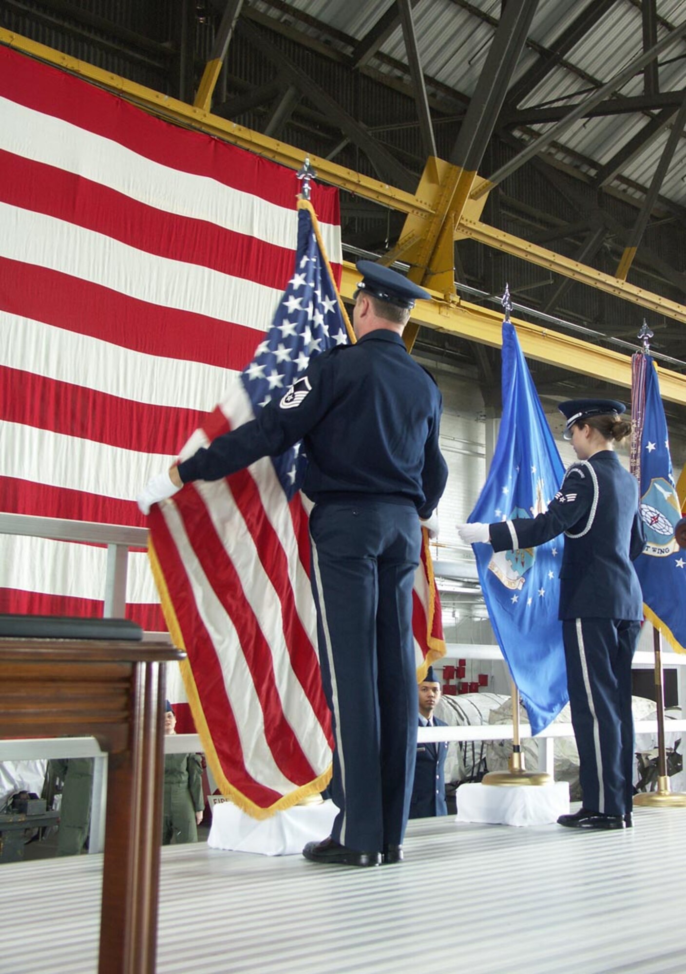 Members of the 932nd Airlift Wing's honor guard prepare the American flag for Col. Maryanne Miller's change of command ceremony.