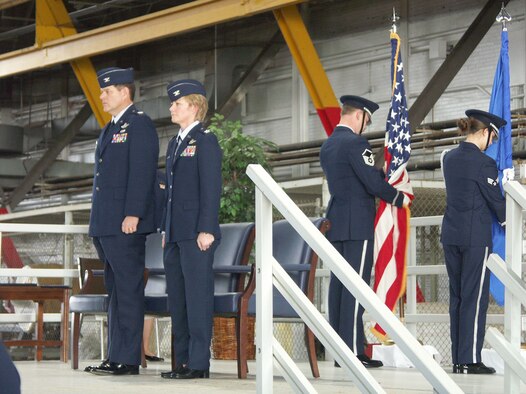 Col. Donald Fletcher Jr., (left) prepares to give command of the wing to Col. Maryanne Miller while the 932nd Airlift Wing honor guard members get the flags positioned.  The even took place on January 8, 2006.  Photo by TSgt. Gerald Sonnenberg.