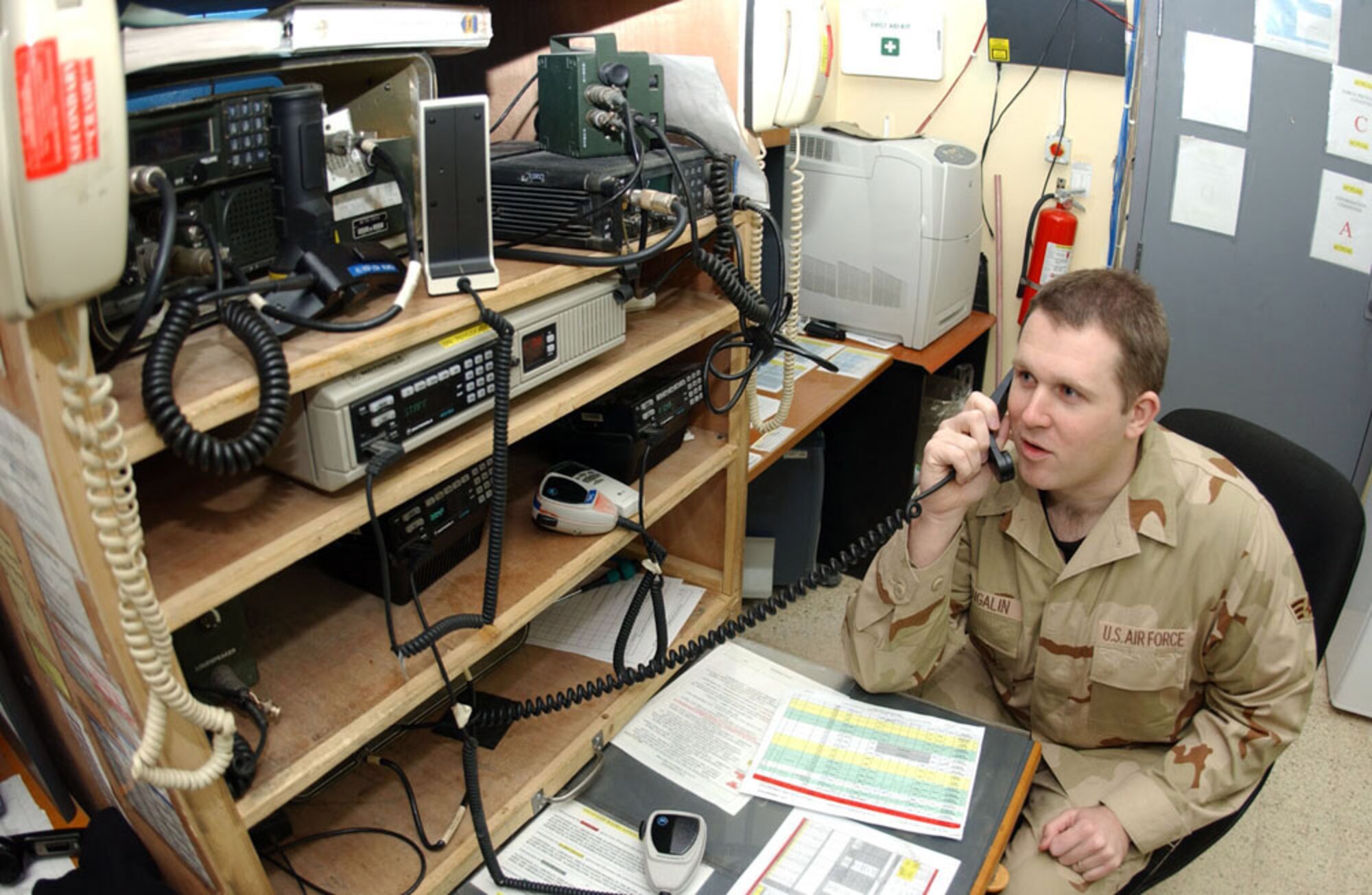BALAD AIR BASE, Iraq -- Senior Airman Jeff Mangalin of the 332nd Air Expeditionary Wing command post, talks to an aircraft preparing to taxi into the base here. (U.S. Air Force photo by Senior Airman Bryan Franks)