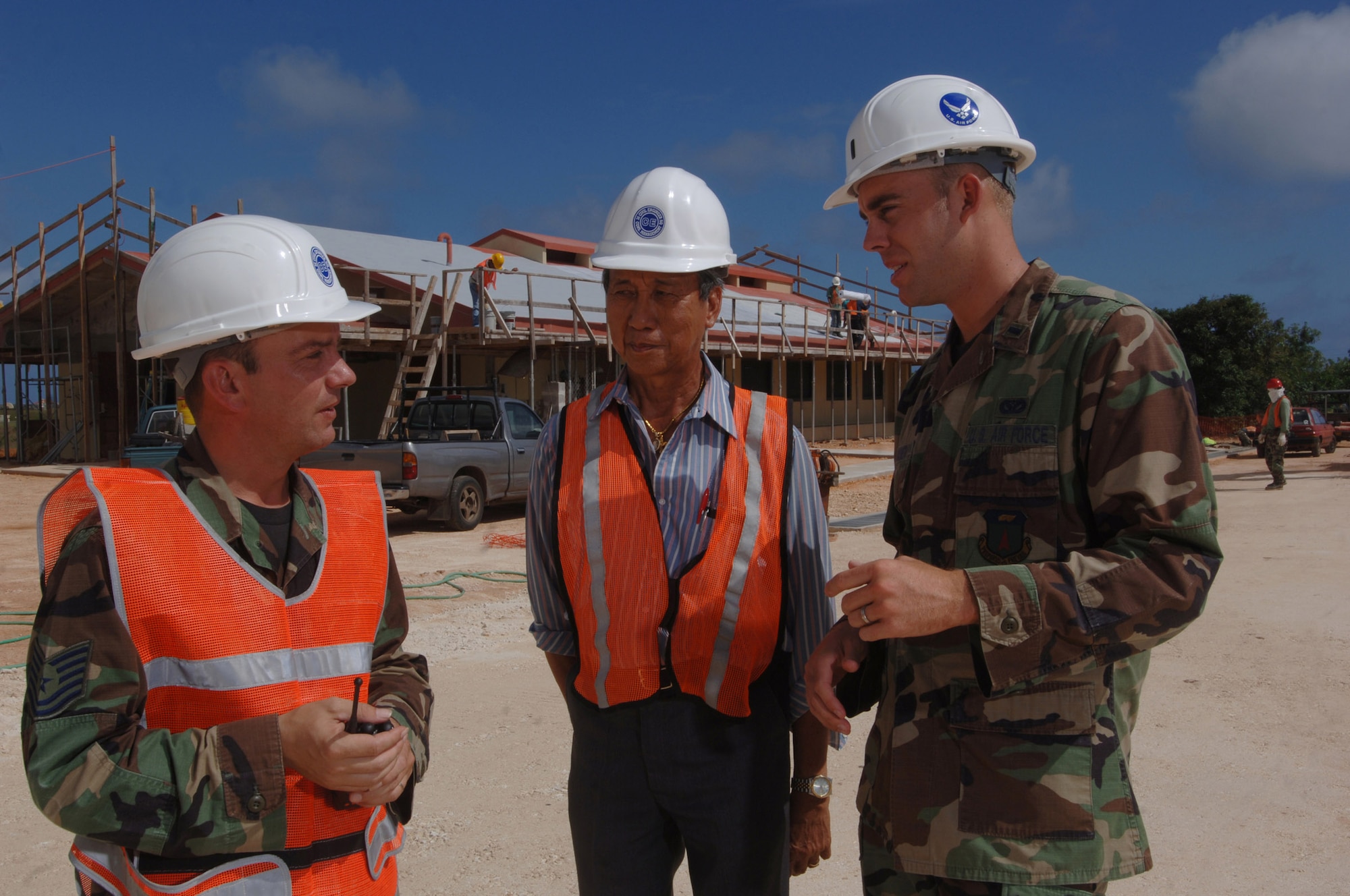 ANDERSEN AIR FORCE BASE, Guam (AFPN) -- (From left) Tech. Sgt. Chris Sorter, Sid Pilarca and 1st Lt. Charles Hansen inspect the progress of the construction of a military working dog facility here. The three are with the 36th Civil Engineer Squadron. They provide day-to-day mission support to military and civilian personnel and 15 associate units here. They also maintain expeditionary capability for Air Force missions deploying to, originating from and transiting through the base. (U.S. Air Force photo by Master Sgt. Val Gempis)