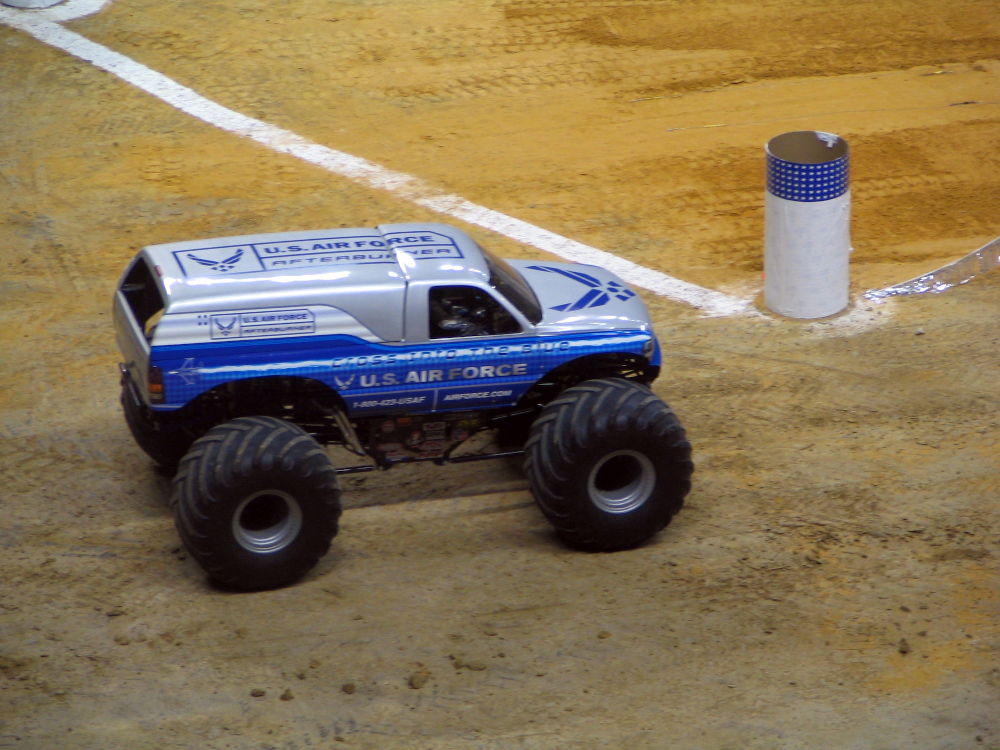 SAN ANTONIO (AFPN) -- Afterburner, the Air Force's new monster truck, takes the corner in the final race against the Grave Digger during the San Antonio Monster Jam, Jan. 14. This is only the second race in which the truck, one of the newest Air Force recruiting tools, has competed. Afterburner, driven by Paul Cohen, made the finals Jan. 14, but was edged out by Grave Digger in the final match. (U.S. Air Force photo by David Raney)