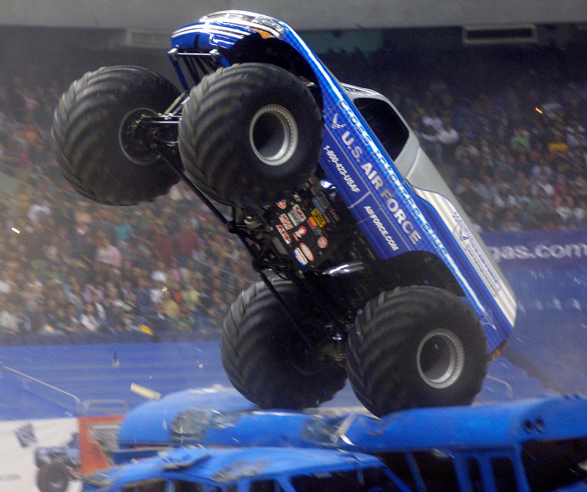 SAN ANTONIO (AFPN) -- Afterburner, the Air Force's new monster truck, jumps over some crushed cars at the San Antonio Monster Jam, Jan. 14. This is only the second race in which the truck, one of the newest Air Force recruiting tools, has competed. Afterburner, driven by Paul Cohen, made the finals Jan. 14, but was edged out by Grave Digger in the final match. (U.S. Air Force photo by Senior Airman Brian Ferguson)