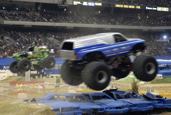 SAN ANTONIO (AFPN) -- Afterburner, the Air Force's new monster truck, leaps over some crushed cars during a race against Grave Digger at the San Antonio Monster Jam, Jan. 14. This is only the second race in which the truck, one of the newest Air Force recruiting tools, has competed. Afterburner, driven by Paul Cohen, made the finals Jan. 14, but was edged out by Grave Digger in the final match. (U.S. Air Force photo by Senior Airman Brian Ferguson)