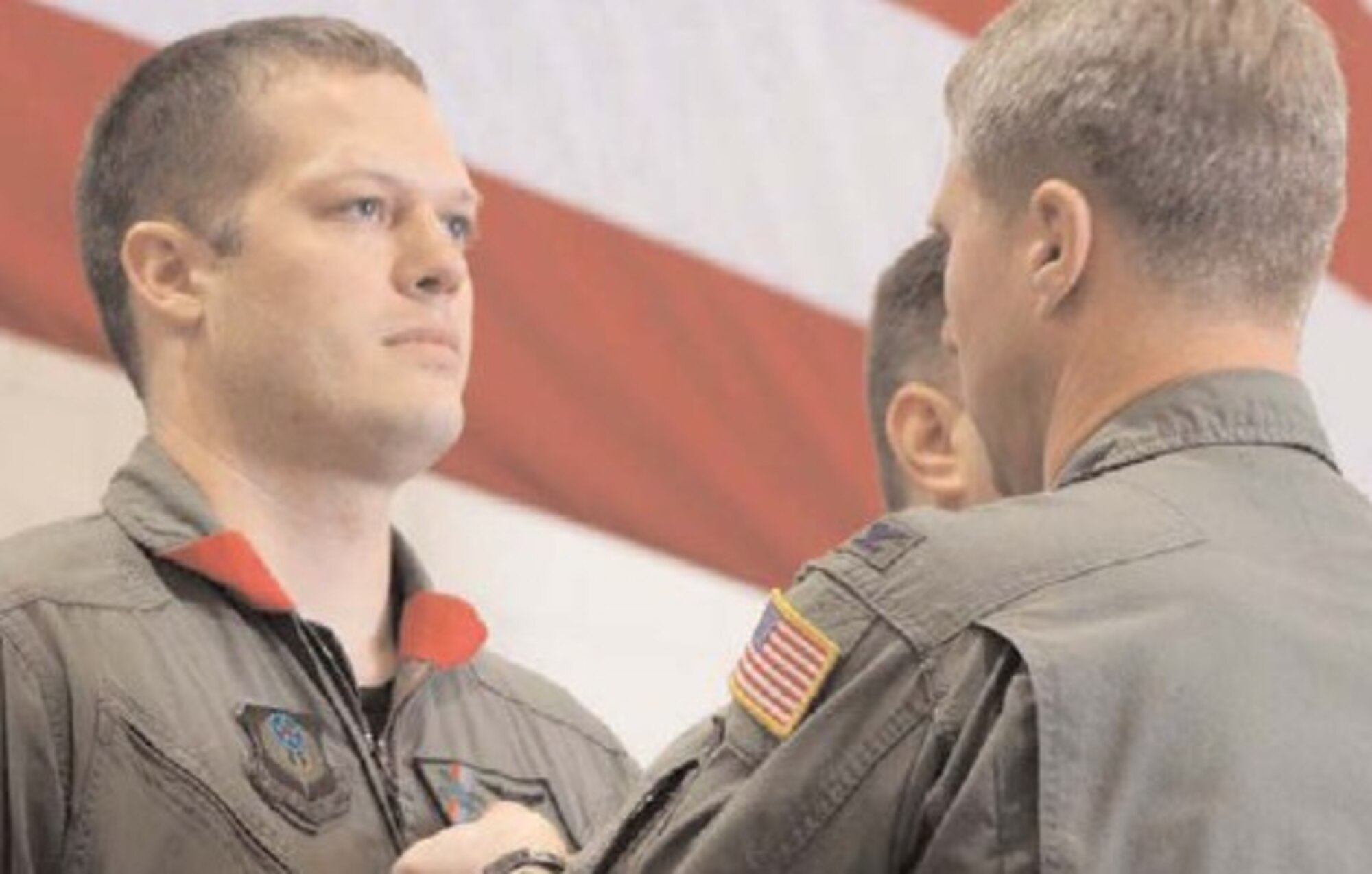 Capt. Matthew Berry, 20th Special Operations Squadron, receives a Distinguished Flying Cross with Valor from Col. Mark Alsid, 16th Operations Group commander, Dec. 16 in Freedom Hanger.