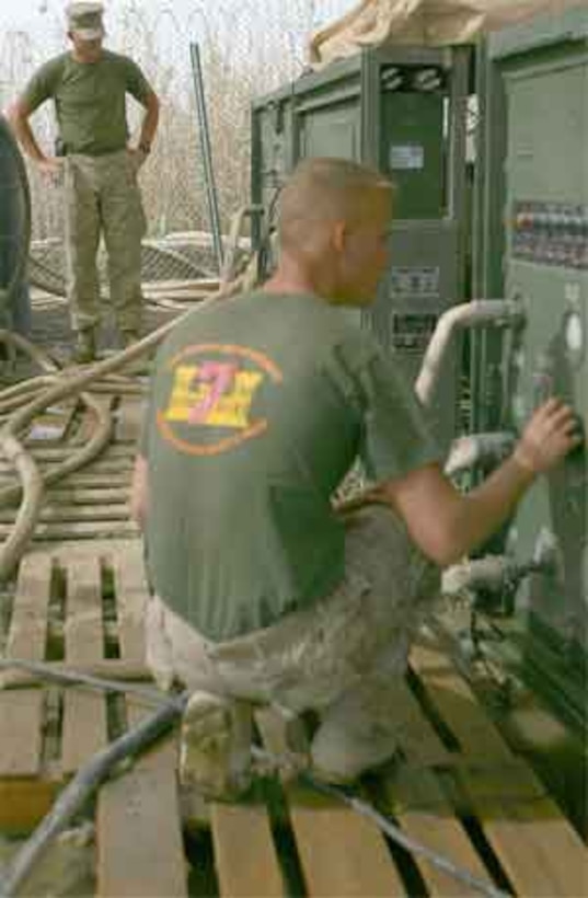 It?s a lot of teamwork and responsibility June 18, 2006 as Sgt. Mark A. Berry and Lance Cpl. Perry R. Schultz run the reverse osmosis water purification unit at Blue Diamond just outside of Ramadi. Berry, a 28-year-old native of Dallas, and his two Marines here utilize the system to produce 15,000 to 18,000 gallons of cleaned, purified and chlorinated water every day for Iraqi Security Forces. Without the water, the ISF would be severely limited in their ability to prepare food, shower and otherwise survive as they conduct missions in the region.