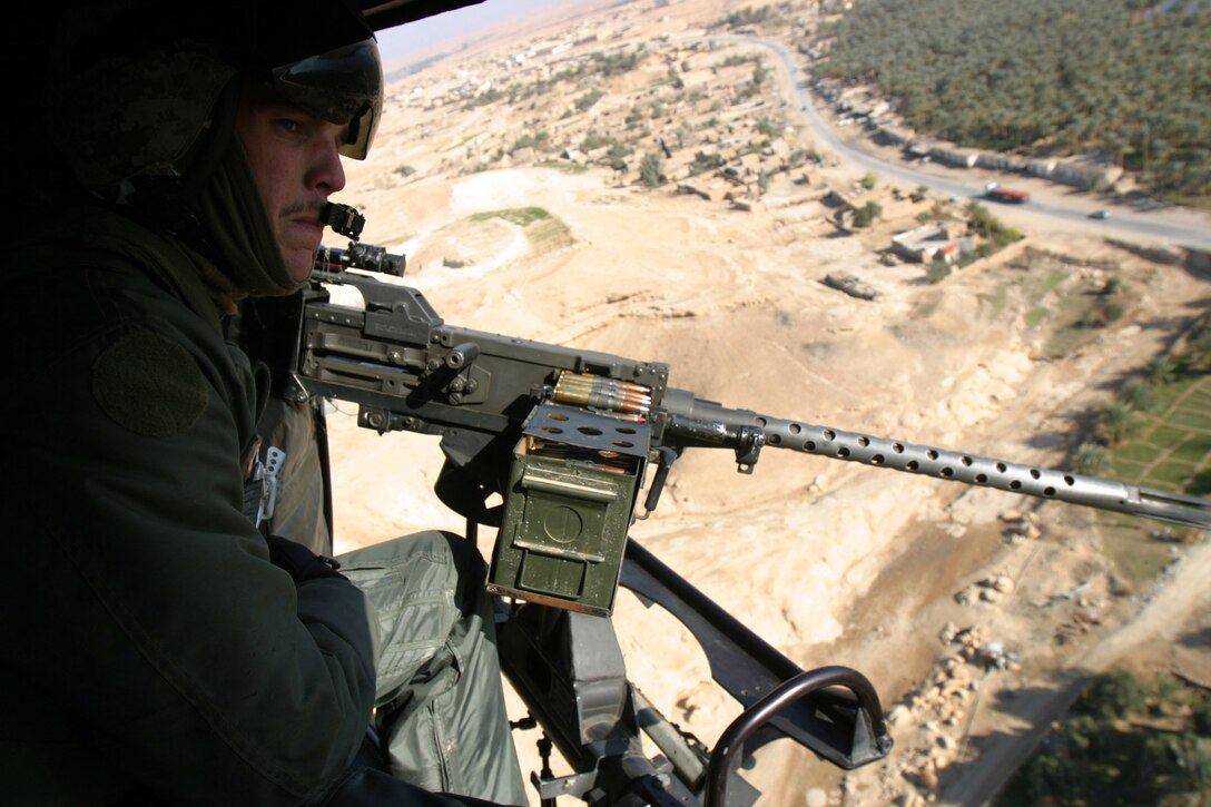 Sergeant Keith F. Diehl, of Richmond Hill, Ga., an aerial observer with Marine Medium Helicopter Squadron 261 (Reinforced), mans a .50 caliber machine gun on a recent flight over Hit, Iraq. The squadron is the aviation combat element for the 22nd Marine Expeditionary Unit (Special Operations Capable) which is conducting counterinsurgency operations with the 2nd Marine Division in Iraq’s Al Anbar province.