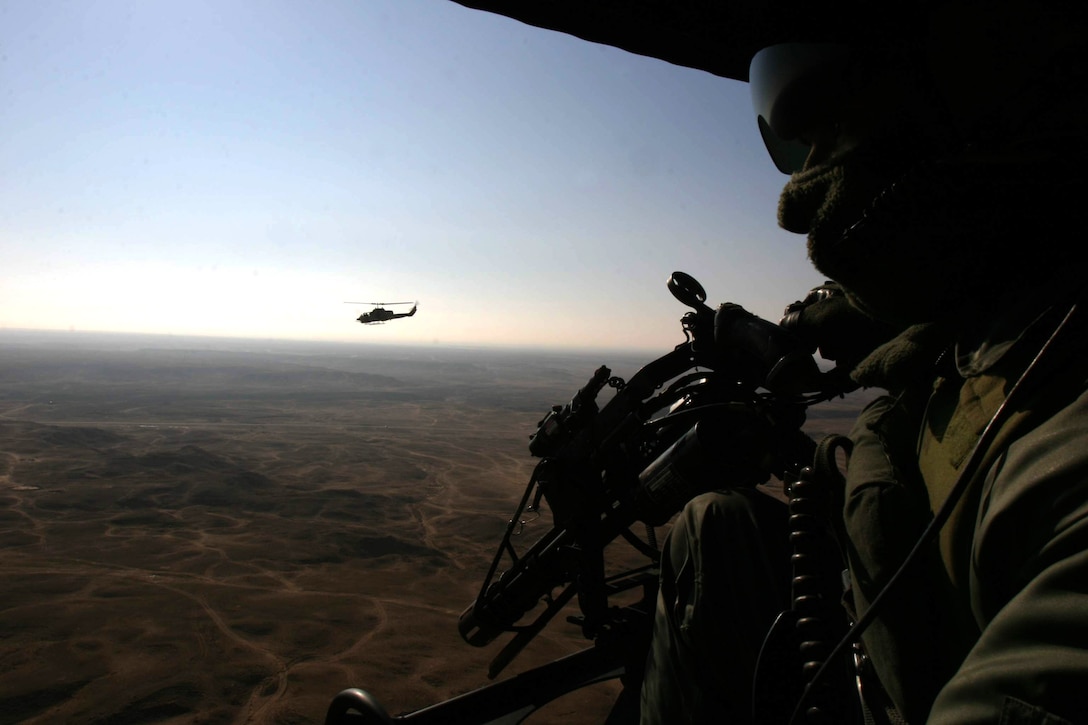 An AH-1W Super Cobra with Marine Medium Helicopter Squadron 261 (Reinforced) stays close to his wingman, a UH-1N Huey also from HMM-261 (Rein.) during a recent mission near Hit, Iraq.  The squadron is the aviation combat element for the 22nd Marine Expeditionary Unit SOC (Special Operations Capable) which is conducting counterinsurgency operations with the 2nd Marine Division in Iraq?s Al Anbar province.