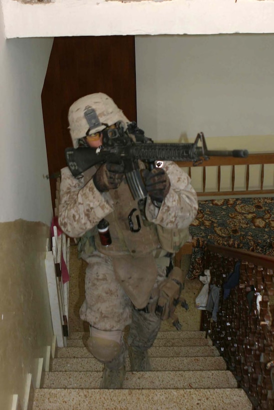 BARWANA, Iraq (Jan. 19, 2006) - Woodland, Calif. native Lance Cpl. Sam E. Smithson, a team leader with Company L, 3rd Battalion, 1st Marine Regiment  sweeps through a house during Operation Red Bull II Jan. 19. Smithson and his team continue to patrol and find weapons caches in the region. (Official Marine Corps photo by Cpl. Adam C. Schnell)