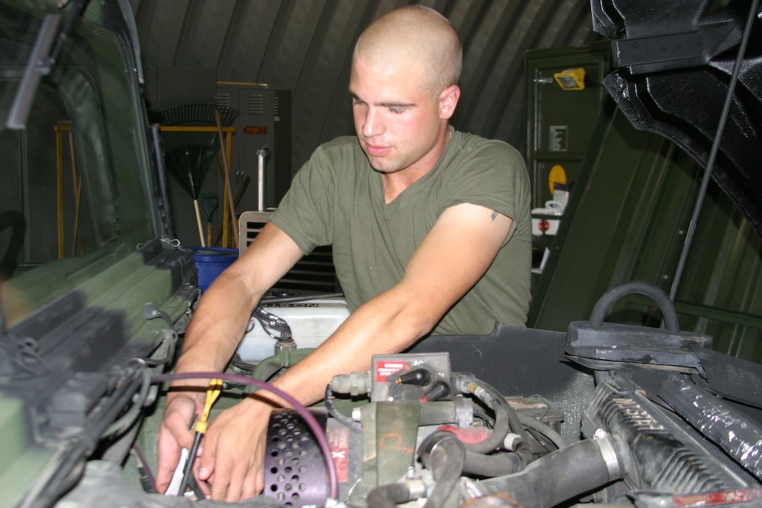 Cpl. John Bubier, a motor transport mechanic for Combat Logistics Company 23, works on replacing glow plugs on a humvee here Tuesday.