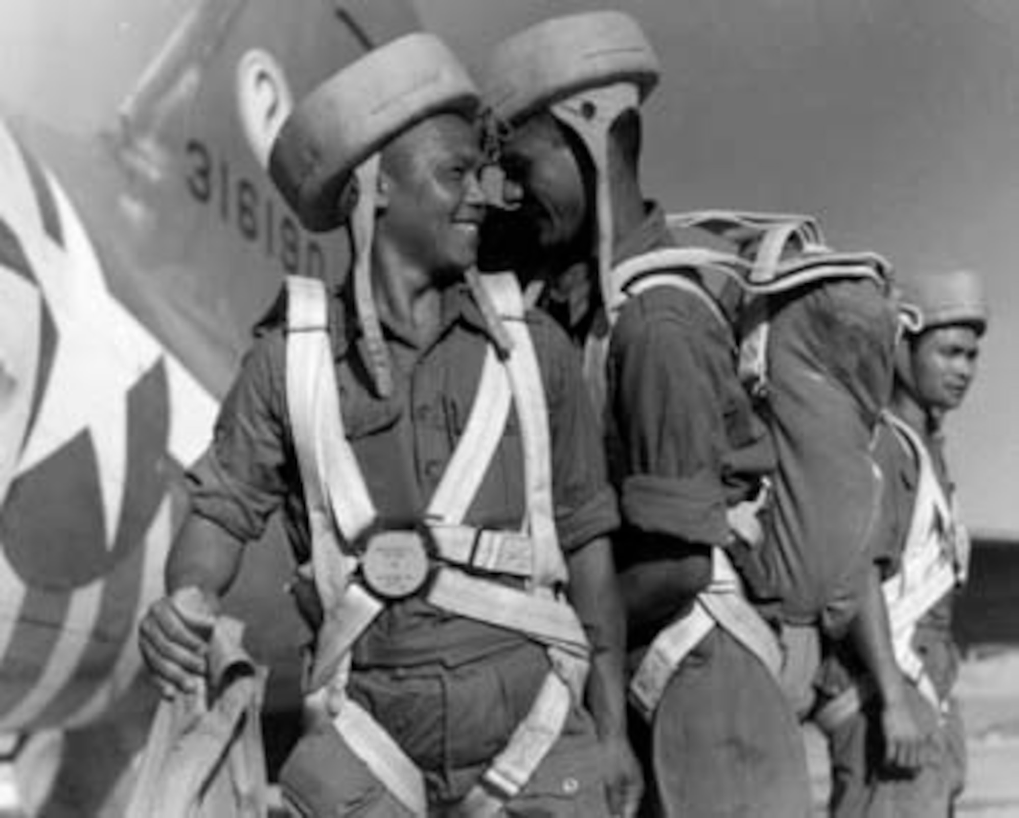 Three Nepalese Gurkhas prepare to board an air commando C-47 bound for Burma. The question mark on the tails of the C-47s came from all the questions air commandos got about the unusual equipment attached to them for snatching gliders.