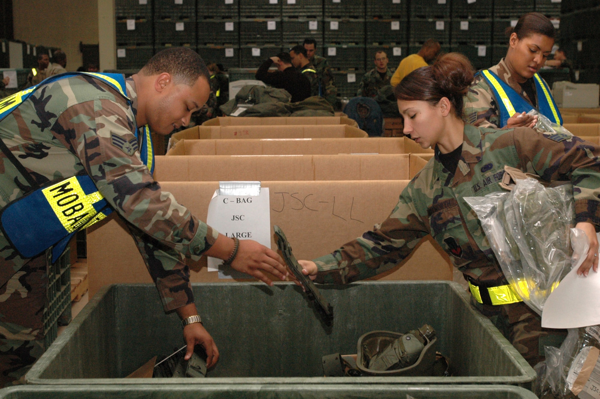 LANGLEY AIR FORCE BASE, Va. (AFPN) -- Airmen team up to assist deploying troops here Jan. 13. (U.S. Air Force photo by Airman Vernon Young)