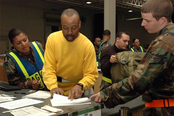 LANGLEY AIR FORCE BASE, Va. (AFPN) -- Civilian employee Marvin Williams (center) briefs an Airman on his upcoming deployment and the gear that he will receive. (U.S. Air Force photo by Airman Vernon Young)