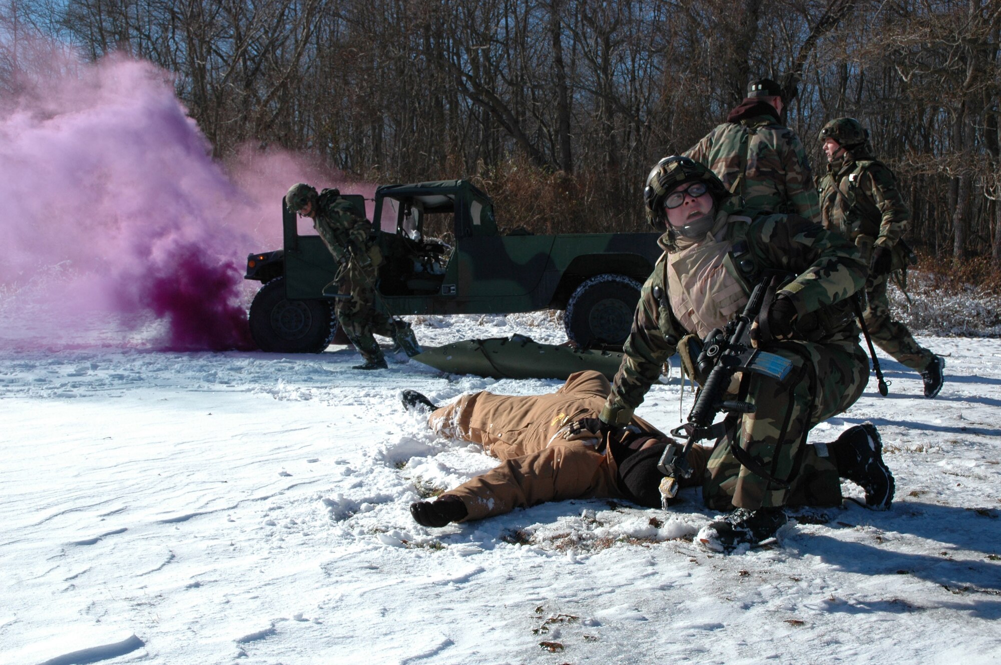 FORT DIX, N.J. -- First Lt. Brooks Roland calls to fellow Airmen for support as he tends to a sucking chest wound during a combat first aid obstacle course here Jan. 15. Lieutenant Roland is a security forces officer with the 621st Contingency Response Wing at McGuire Air Force Base, N.J. (U.S. Air Force photo by Staff Sgt. Bryan Bouchard)