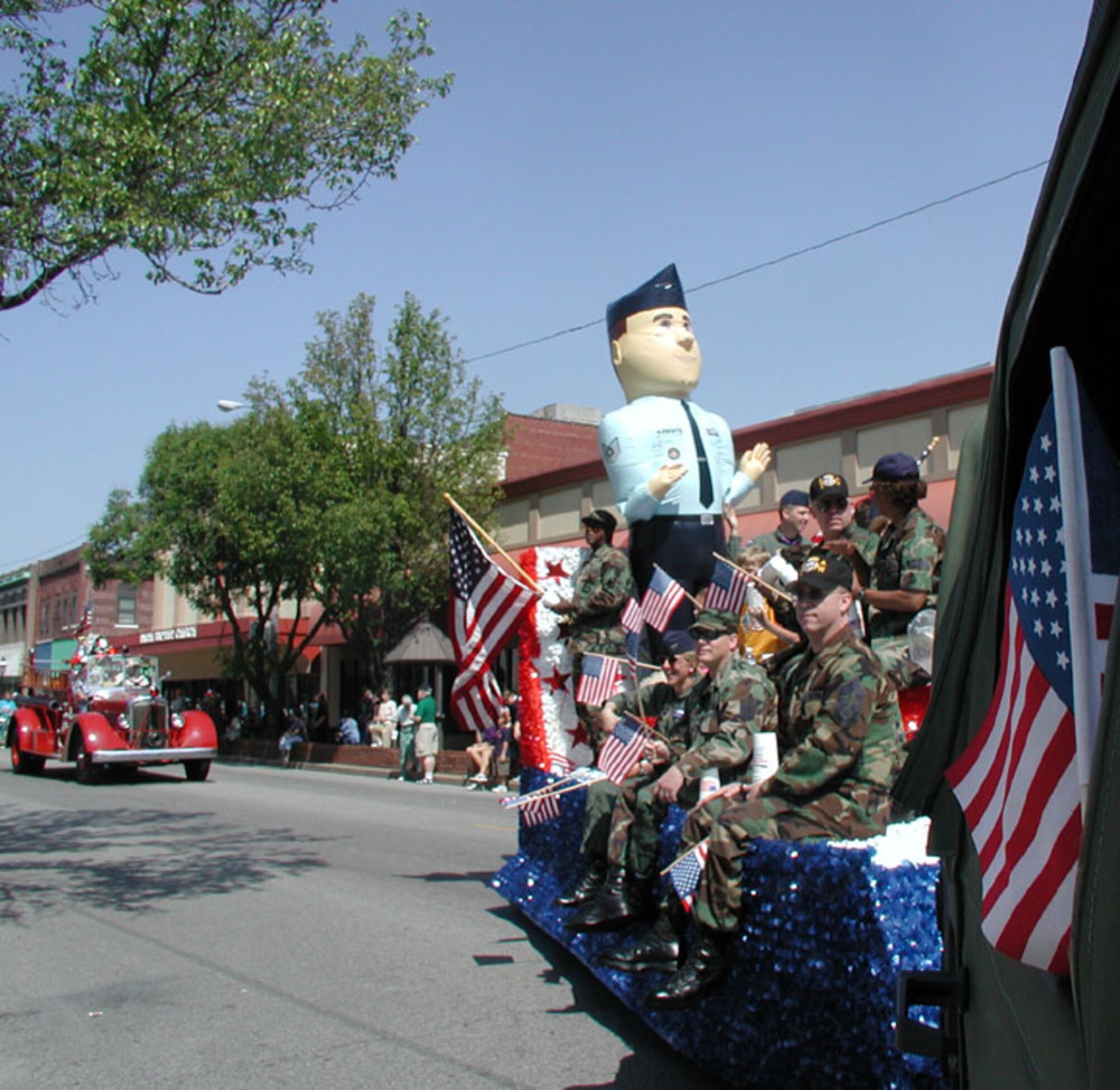 A giant "recruiter" follows the 932nd Airlift Wing Memorial Day parade float.  Want to join the Air Force Reserve?  Call 1-800-257-1212.