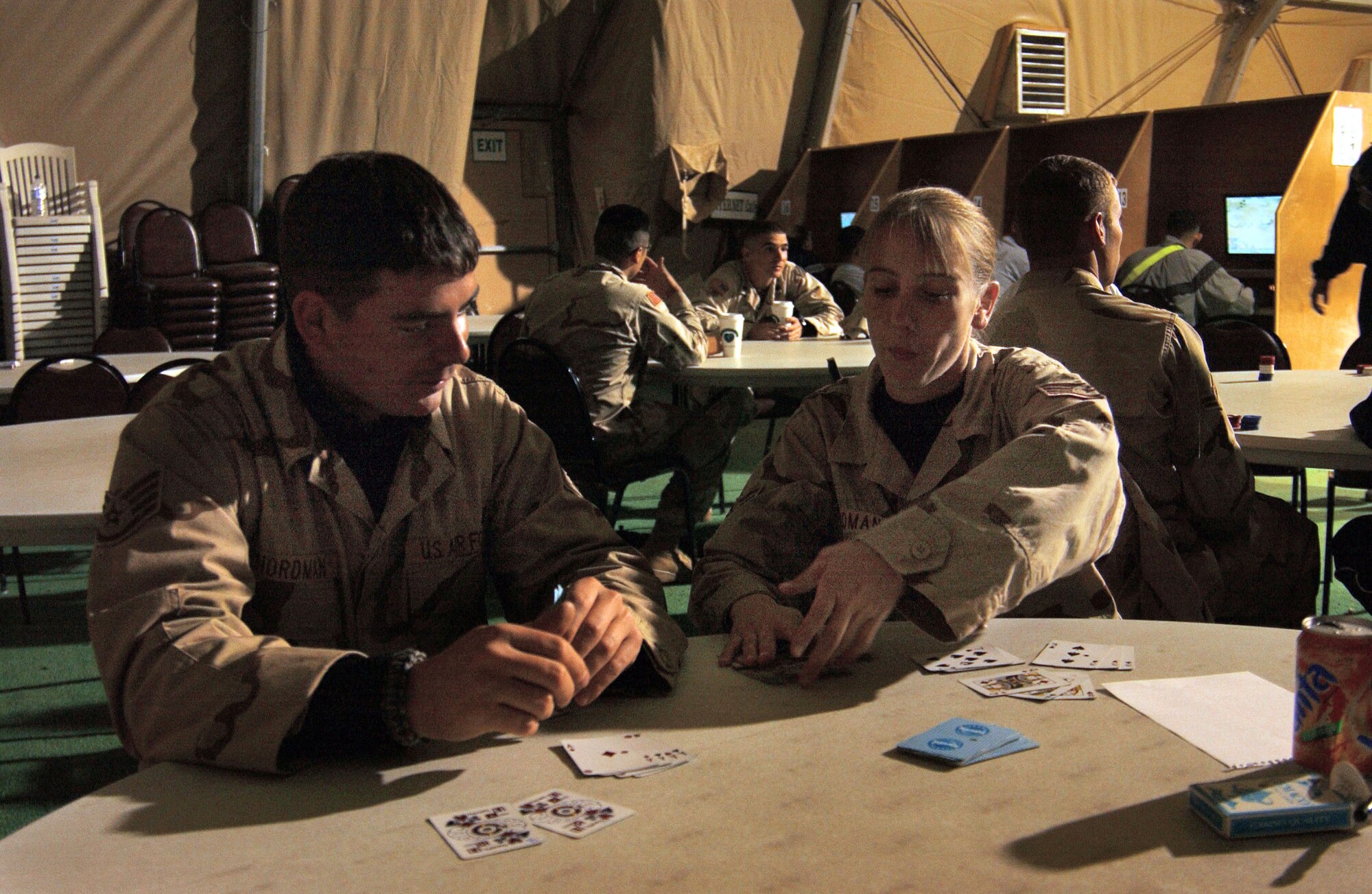 BALAD AIR BASE, Iraq (AFPN) -- Staff Sgts. Craig and Millie Nordman enjoy a game of cards during their off-duty time at the recreation tent. The two sergeants have been married for four and a half years and are deployed here with 332nd Expeditionary Civil Engineering Squadron for Air and Space Expeditionary Force 7/8. (U.S. Air Force photo by Staff Sgt. Tammie Moore)