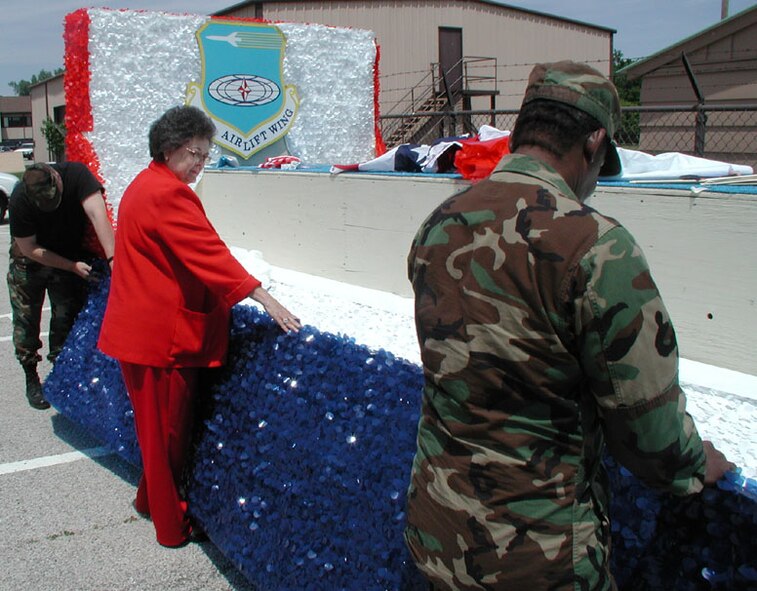 Jeri Hohrein and members of the 932nd Airlift Wing prepare the unit's float for Memorial Day.  The wing annually participates in giving back to the community during the parade and memorial services.