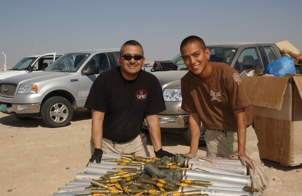 Chief Master Sgt. Julio Morelos and Staff Sgt. Julio Morelos III work together on an Explosive Ordnance Disposal demolition.  Chief Morelos works as the EOD Program Manager with the Combined Air Operations Center and Sergeant Morelos works with the 379th Civil Engineer Squadron.  Chief Morelos is deployed from Tyndall Air Force Base, Fla. and his son is deployed from Eglin Air Force Base, Fla.  (Air Force photo by Master Sgt. Stanley Coleman)
