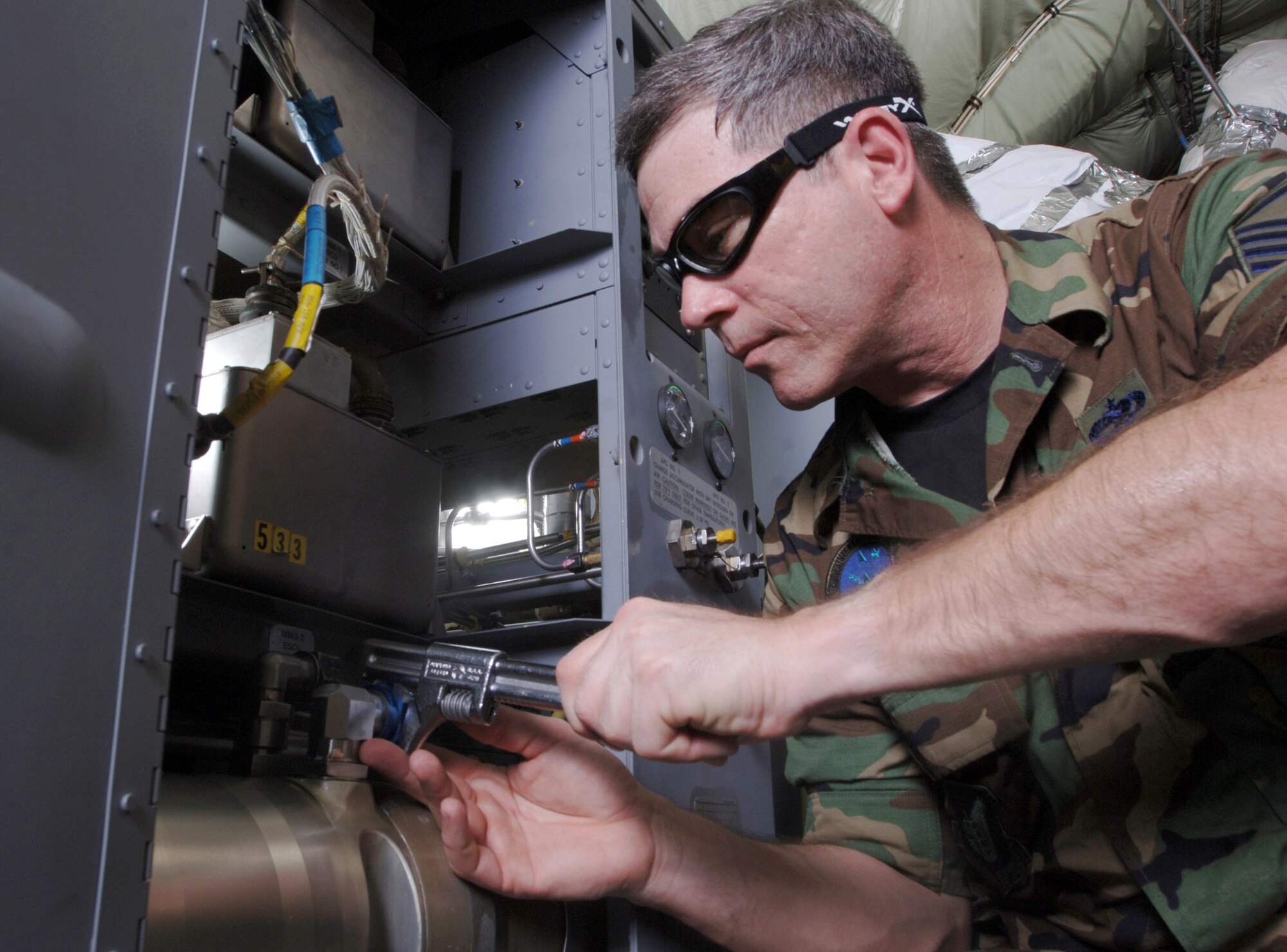 ANDERSEN AIR FORCE BASE, Guam (AFPN) -- Master Sgt. Jerry Boynton uses a wrench to remove a line on an auxilliary power unit inside a KC-135 Stratotanker. Sergeant Williams is a hydraulic technician with the 168th Air Refueling Wing of the Alaska Air National Guard at Eielson Air Force Base. (U.S. Air Force photo by Master Sgt. Val Gempis)