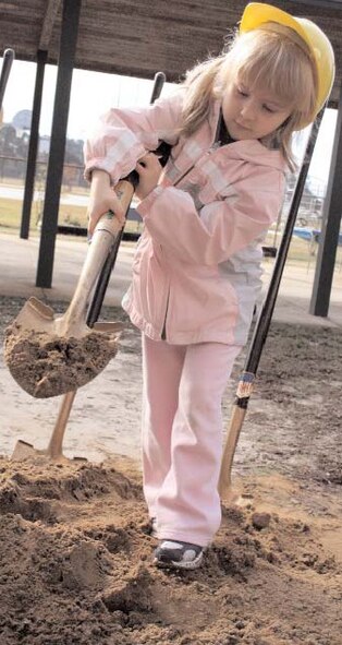 Megan Stanford, daughter of Tech. Sgts. John Stanford, 823rd RED HORSE Squadron, and Cynthia Stanford, 16th Maintenance Operations Squadron, does her share of digging during the groundbreaking Tuesday at the child development center.
