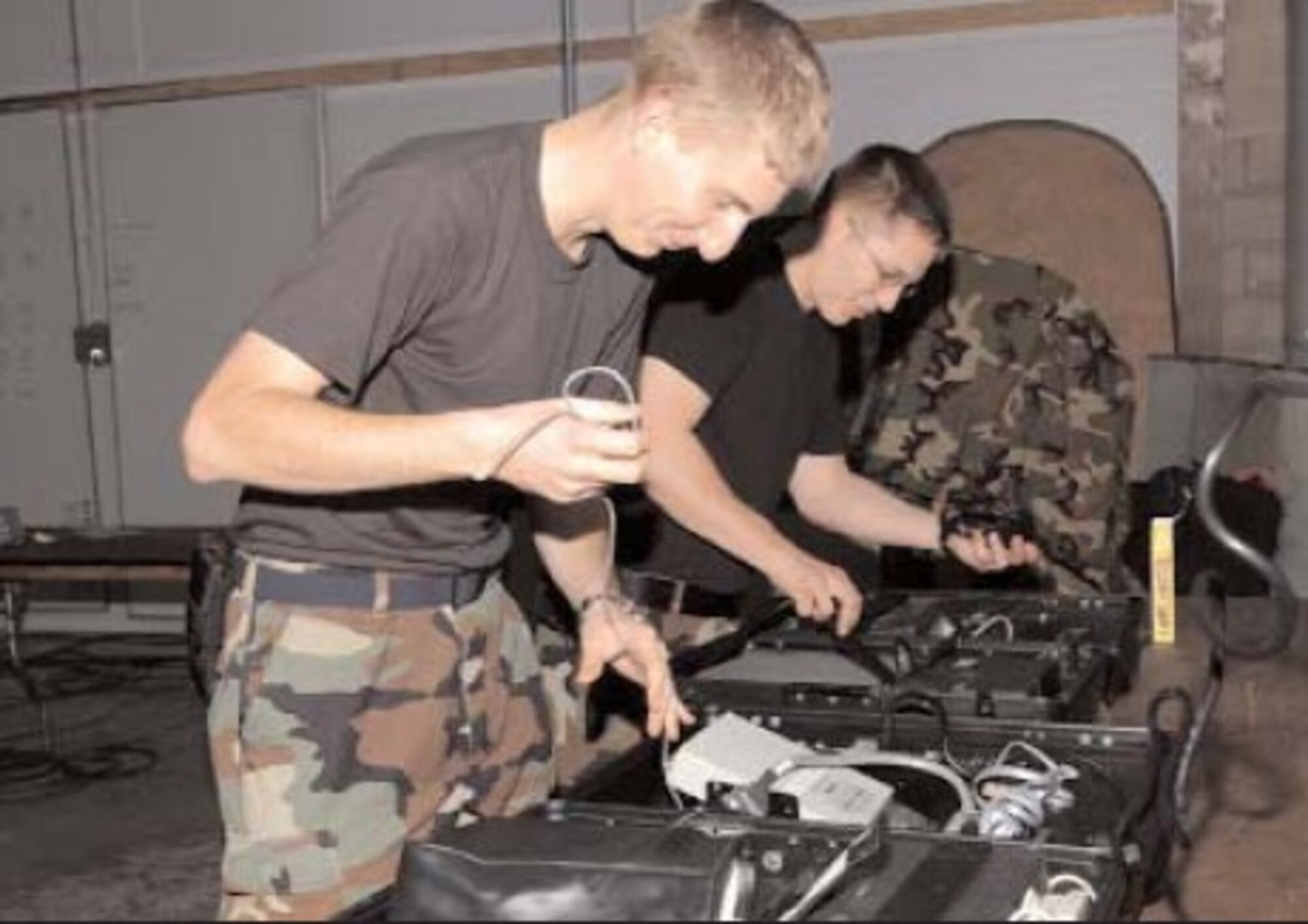 Airman 1st Class Gary Kilmer (front) and Senior Airman Matthew Dale, 16th Communications Squadron, set up radio equipment during a base-wide exercise Dec. 5, in preparation for an Operation Readiness Inspection next spring. Hurlburt Field will have several exercises before the ORI to ensure all base personnel are prepared for the evaluation.