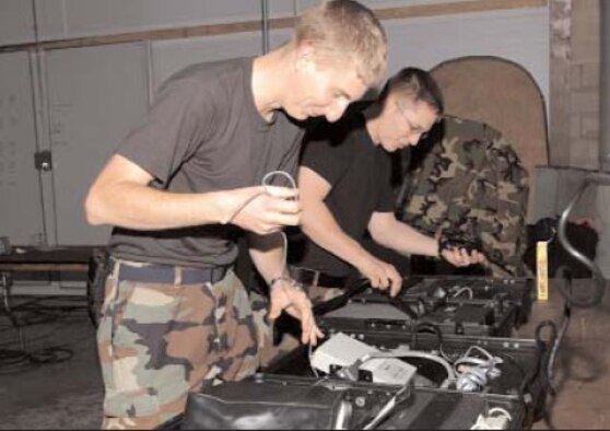 Airman 1st Class Gary Kilmer (front) and Senior Airman Matthew Dale, 16th Communications Squadron, set up radio equipment during a base-wide exercise Dec. 5, in preparation for an Operation Readiness Inspection next spring. Hurlburt Field will have several exercises before the ORI to ensure all base personnel are prepared for the evaluation.