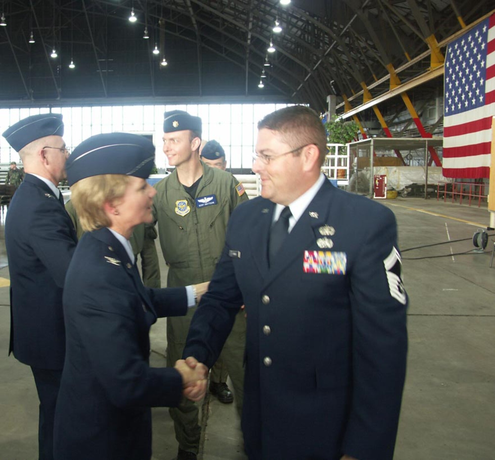 SMSgt. Todd Wadkins, safety office NCOIC, gives his congratulations to the new wing commander, Col. Maryanne Miller as she takes over the top leadership role of commander for the 932nd Airlift Wing at Scott AFB, Il.  Photo by TSgt. Gerald Sonnenberg.