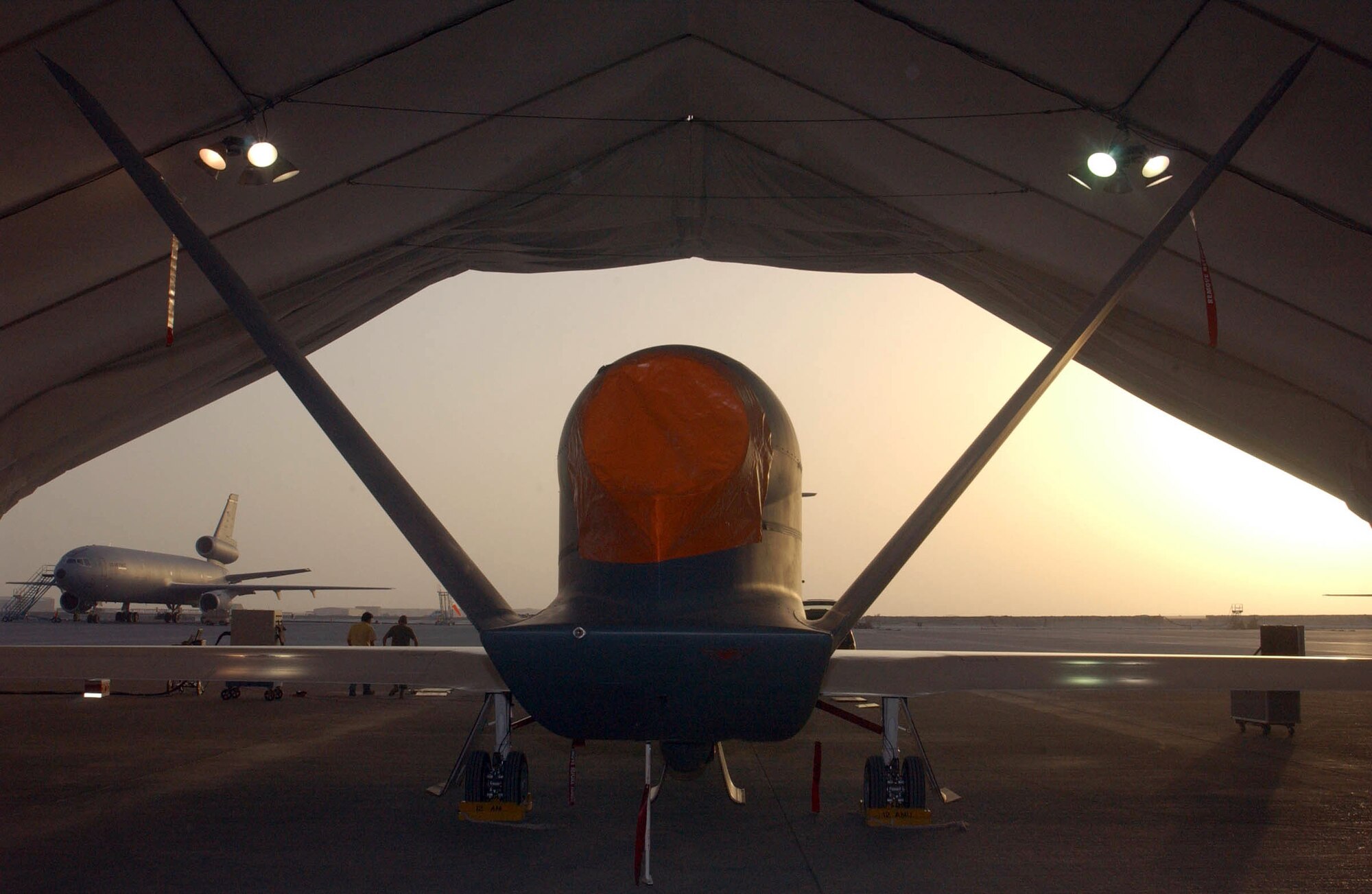 SOUTHWEST ASIA (AFPN) -- A Global Hawk rests in its hangar on the flightline of this desert base. The unmanned aerial vehicle is the Air Force's first deployed production Global Hawk, and is one of two deployed here. It is the first deployment of the UAV production models. Previous Global Hawks were prototypes or test models. (U.S. Air Force photo by Tech. Sgt. Mike Hammond)
