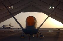 SOUTHWEST ASIA (AFPN) -- A Global Hawk rests in its hangar on the flightline of this desert base. The unmanned aerial vehicle is the Air Force's first deployed production Global Hawk, and is one of two deployed here. It is the first deployment of the UAV production models. Previous Global Hawks were prototypes or test models. (U.S. Air Force photo by Tech. Sgt. Mike Hammond)