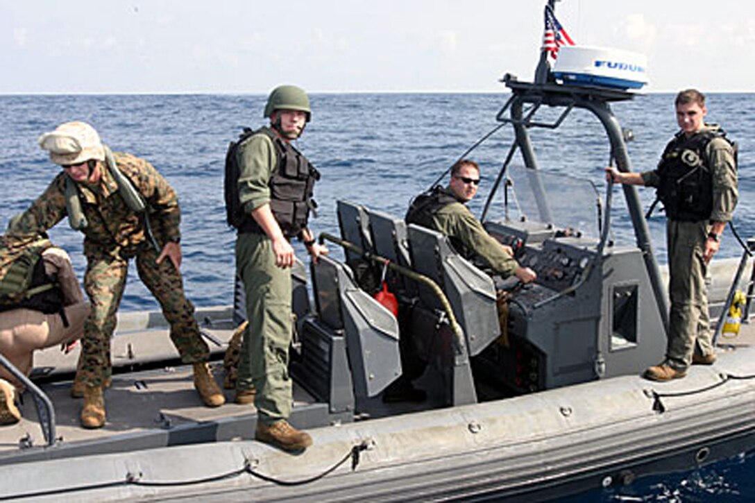 ABOARD USS DUBUQUE (LPD-8) (Oct 18, 2006)--Marines from Rigid Hull Inflatable Boat detachment, Battalion Landing Team 2/4, 15th Marine Expeditionary Unit (Special Operations Capable), await  the order to extract Marines off the USCGS Midgett during a Visit, Board, Search and Seizure exercise. The 15th MEU (SOC), part of Expeditionary Strike Group 5 aboard the USS Boxer (LHD-4), USS Dubuque (LPD-8) and the USS Comstock (LSD 45), is currently deployed in the Western Pacific Region.  (Official USMC Photo by Staff Sgt Alex Popescu) (Released)