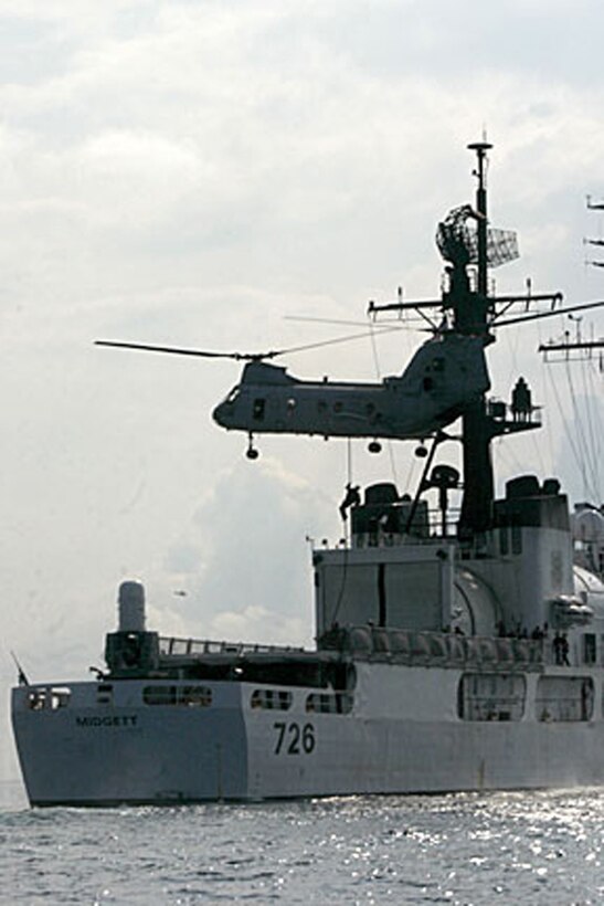 ABOARD USS DUBUQUE (LPD-8) (Oct 18, 2006)--A Marine from Maritime Special Purpose Force, 15th Marine Expeditionary Unit (Special Operations Capable), fast ropes from a CH-46E Seaknight onto the USCGS Midgett during a Visit, Search and Seizure exercise.  The 15th MEU (SOC), part of Expeditionary Strike Group 5 aboard the USS Boxer (LHD-4), USS Dubuque (LPD-8) and the USS Comstock (LSD 45), is currently deployed in the Western Pacific Region. (Official USMC Photo by Staff Sgt Alex Popescu) (Released)