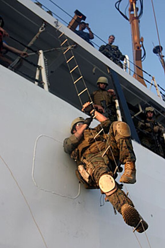 ABOARD USS DUBUQUE (LPD-8) (Oct 18, 2006)--A Marine from Maritime Special Purpose Force, 15th Marine Expeditionary Unit (Special Operations Capable), climbs aboard the USCGS Midgett during a Visit, Boarding, Search and Seizure exercise . The 15th MEU (SOC), part of Expeditionary Strike Group 5 aboard the USS Boxer (LHD-4), USS Dubuque (LPD-8) and the USS Comstock (LSD 45), is currently deployed in the Western Pacific Region. (Official USMC Photo by Staff Sgt Alex Popescu) (Released)