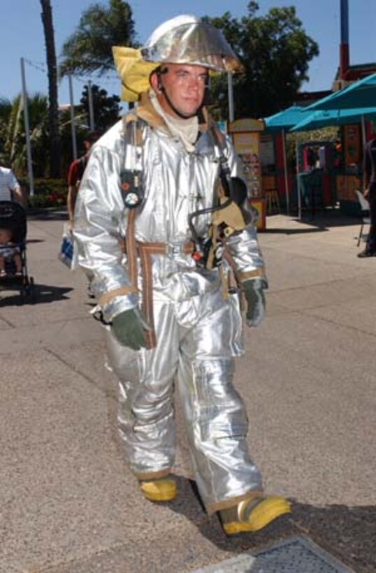 Lance Cpl. Wesley Eastis, crew chief, Aircraft Rescue and Firefighting, Marine Corps Air Station Miramar, takes a break from working the static display at SeaWorld?s ?Sea to Shining Sea? music festival Sept. 18. Eastis continually walked around in his bunker gear in high temperatures, in an effort to attract even more attention for ARFF.