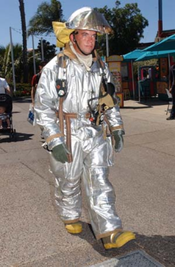 Lance Cpl. Wesley Eastis, crew chief, Aircraft Rescue and Firefighting, Marine Corps Air Station Miramar, takes a break from working the static display at SeaWorld?s ?Sea to Shining Sea? music festival Sept. 18. Eastis continually walked around in his bunker gear in high temperatures, in an effort to attract even more attention for ARFF.