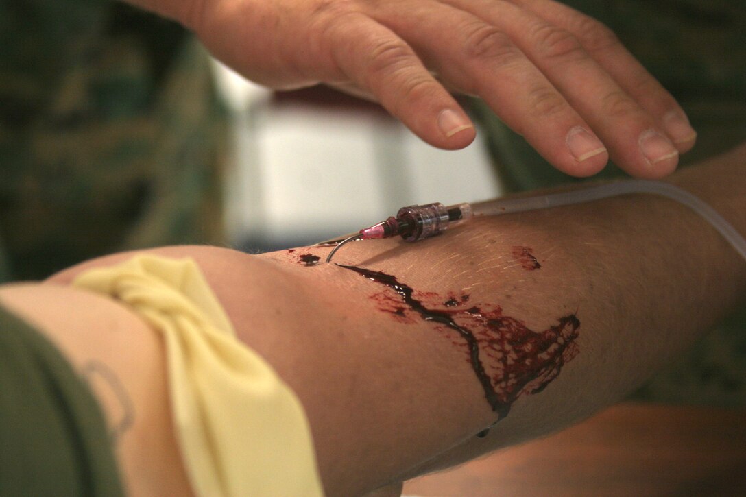 MARINE CORPS BASE CAMP LEJEUNE, N.C. (July 11, 2006) - Starting an intravenous line is just one of the many things students in the Combat Lifesaver Course learn how to do.  The four-day course is geared towards Marines who are preparing to deploy overseas.