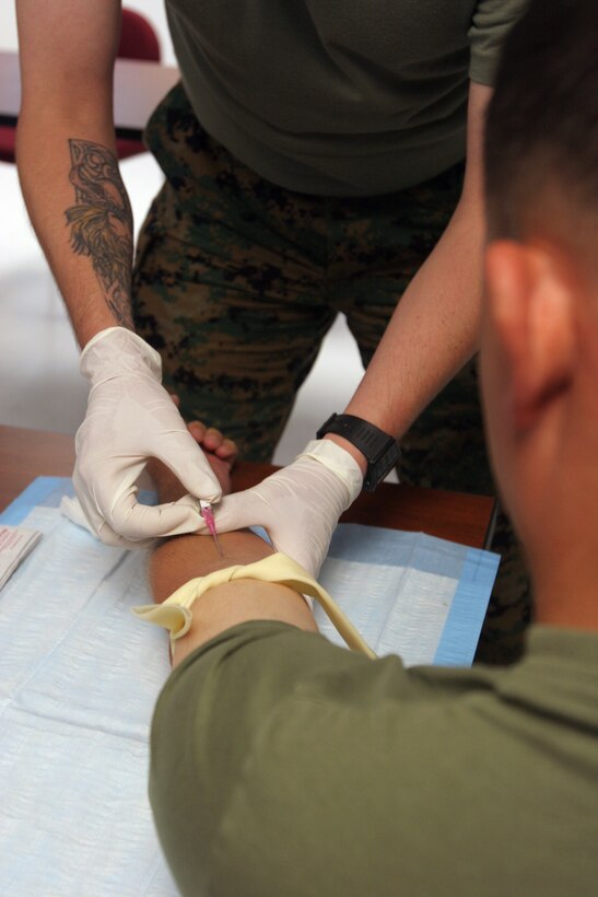 MARINE CORPS BASE CAMP LEJEUNE, N.C. (July 11, 2006) - Starting an intravenous line is just one of the many things students in the Combat Lifesaver Course learn how to do.  The four-day course is geared towards Marines who are preparing to deploy overseas.