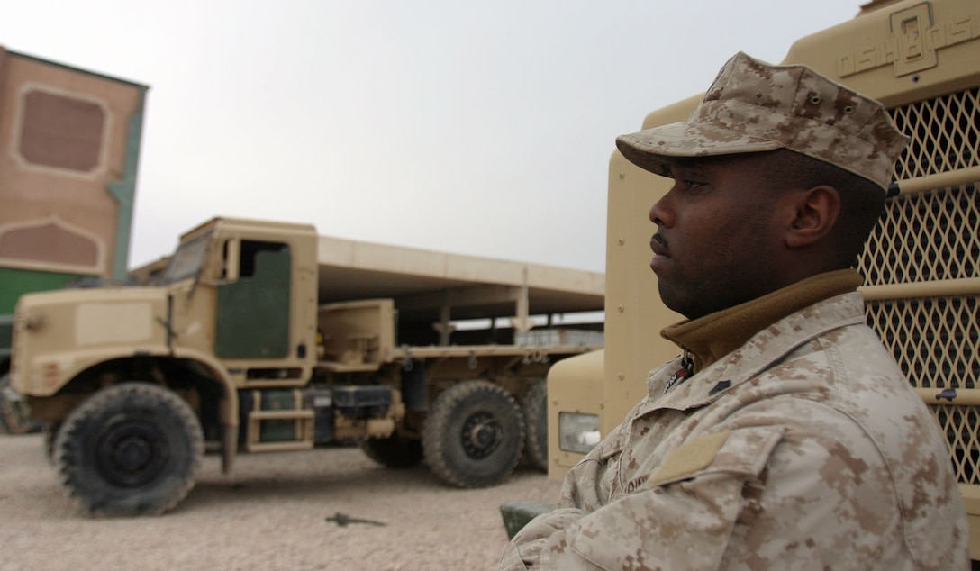 CAMP AL QA'IM, Iraq (Jan. 20, 2006) -- Manning, S.C., native Sgt. Antwoin L. Hilton, platoon sergeant, Motor Transport Section, 3rd Battalion, 6th Marine Regiment, Regimental Combat Team - 2 stands next to the staple of his work -- the 7-ton truck.  (Official U.S. Marine Corps photo by Sgt. Jerad W. Alexander)