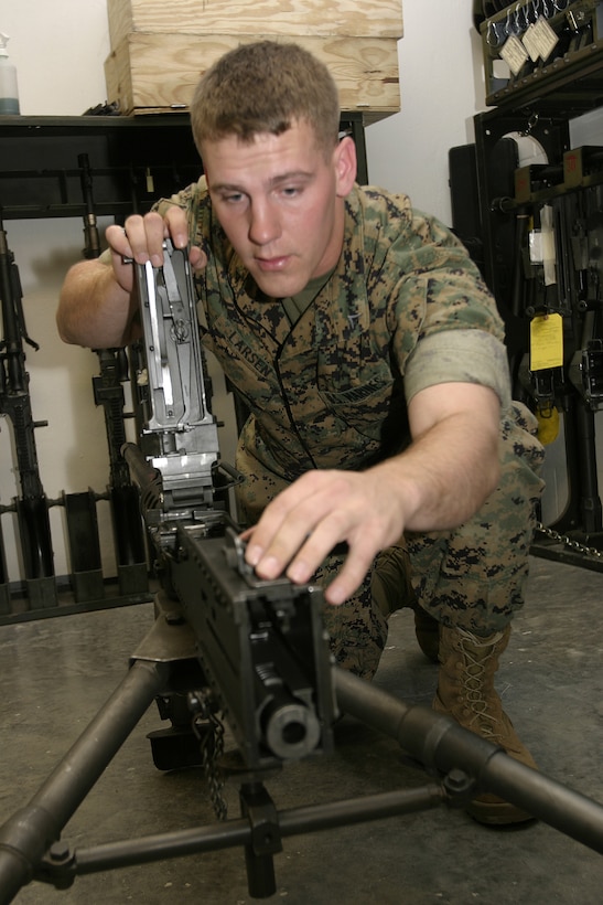MARINE CORPS BASE CAMP LEJEUNE, N.C. - Lance Cpl. Brian J. Larsen, a small arms repair technician with Headquarters Battalion, 2nd Marine Division, inspects the components of an M2 .50 caliber machinegun inside the armory here April 19.  Larsen, a 22-year-old Clarkston, Mich., native, and several other Marines work to keep more than 1,000 rifles, shotguns and machineguns operational for the Marines and sailors in the battalion.