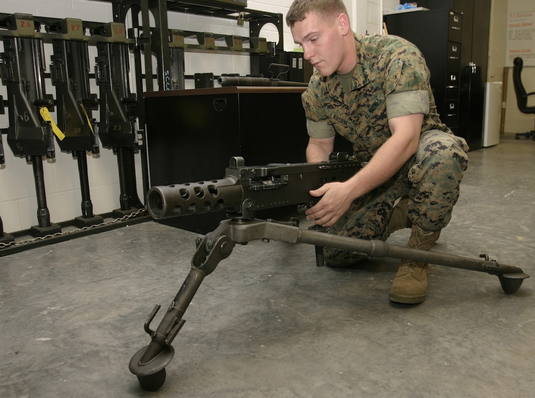 MARINE CORPS BASE CAMP LEJEUNE, N.C. - Lance Cpl. Brian J. Larsen, a small arms repair technician with Headquarters Battalion, 2nd Marine Division, inspects the components of an M2 .50 caliber machinegun inside the armory here April 19.  Larsen, a 22-year-old Clarkston, Mich., native, and several other Marines work to keep more than 1,000 rifles, shotguns and machineguns operational for the Marines and sailors in the battalion.