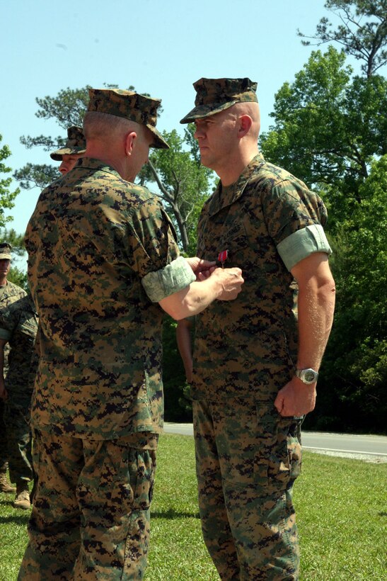 MARINE CORPS BASE CAMP LEJEUNE, N.C. (May 19, 2006)- Maj. Toby G. Dyer, logistics officer for Regimental Combat Team-8, 2nd Marine Division, receives the Bronze Star from Maj. Gen. Richard A. Huck, the 2nd Marine Division Commanding General in a ceremony in front of the regiment's headquarters May 19.
