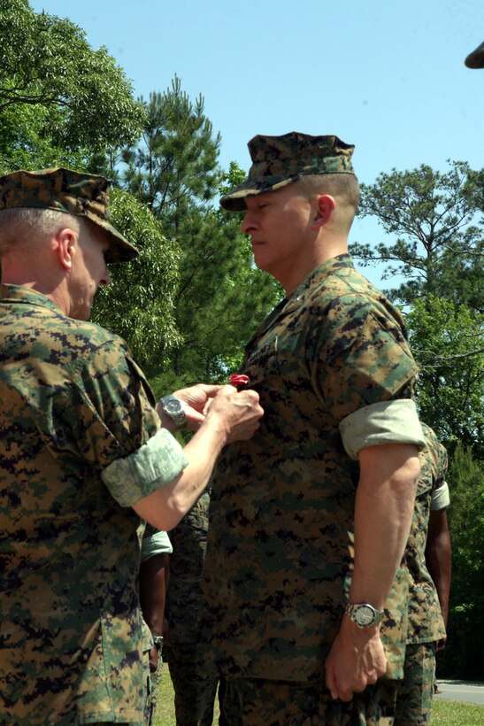 MARINE CORPS BASE CAMP LEJEUNE, N.C. (May 19, 2006)- Lt. Col. Richard O. Miles Jr., executive officer for Regimental Combat Team 8, 2nd Marine Division receives the Bronze Star from Maj. Gen. Richard A. Huck, the 2nd Marine Division Commanding General in a ceremony in front of the regiment's headquarters May 19.