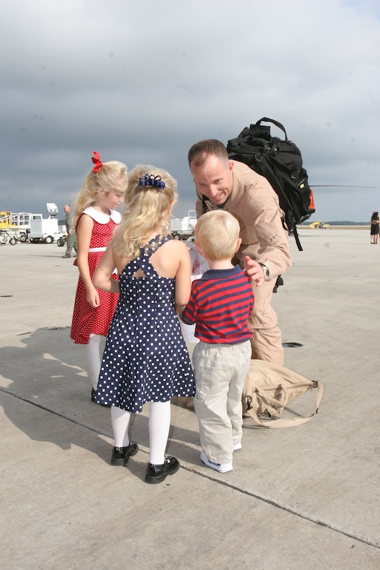 Maj. Brian N. Pinckard is welcomed home Oct. 18 by his nieces, Kaitlyn Pastino, 5, and Meghan Pastino, 3, and nephew Conner Pastino, 2. Pinckard and his team provided operational airlift support during a deployment to Al Udeid Air Base, Qatar in support of the Global War on Terrorism.