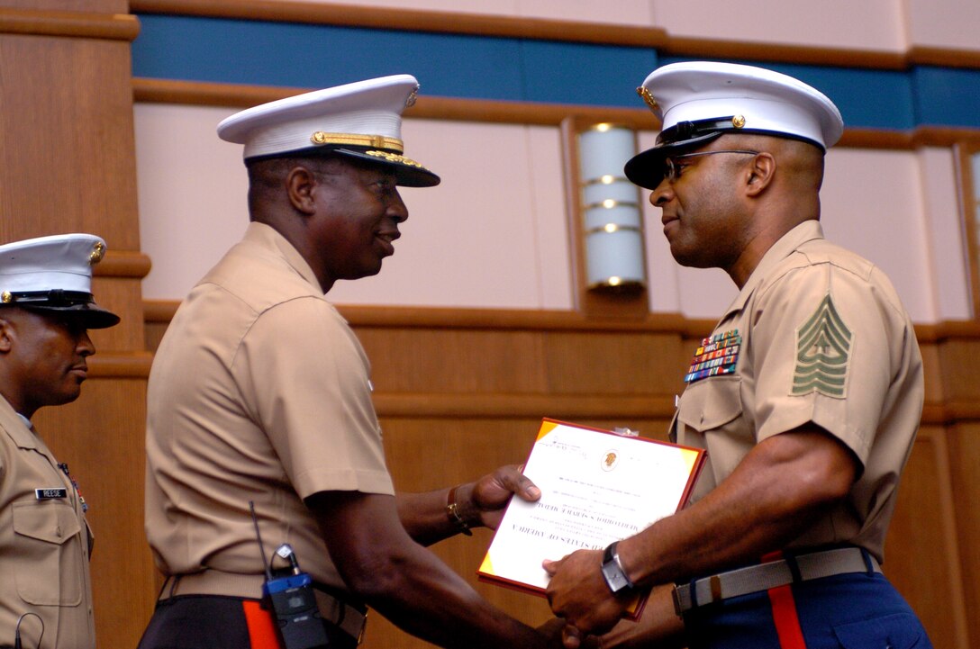 Major Gen. Walter E. Gaskin, commanding general, Marine Corps Recruiting Command, Quantico, Va., awards Sergeant Major James Futrell during a relief and appointment ceremony held at the Al Gray Research Center May 19, 2006. Futrell relinquished his post to Sgt. Maj. Fenton Reese as the new sergeant major of Marine Corps Recruiting Command.