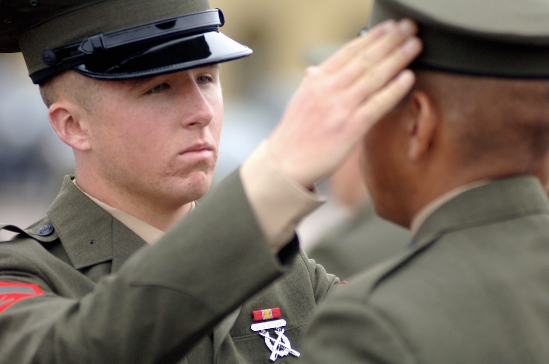 Lance Cpl.  Travis L. Gruber, Platoon 2077, Company G., walks along the platoon?s formation during the battalion commander?s final inspection of the company on Shepherd Memorial Drill Field Tuesday. During the inspection, recruits are tested on common Marine Corps knowledge and bearing.