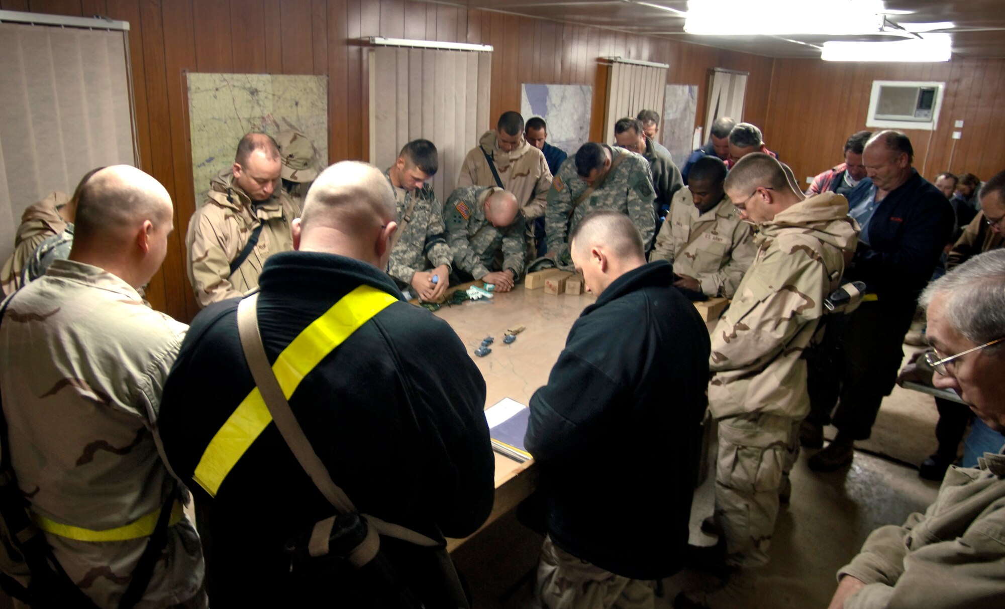 BALAD AIR BASE, Iraq (AFPN) -- Airmen, Soldiers and civilians pray before heading out on a convoy mission. The Airmen are with the 732nd Expeditionary Logistics Readiness Squadron. (U.S. Air Force photo by Master Sgt. Lance Cheung) 