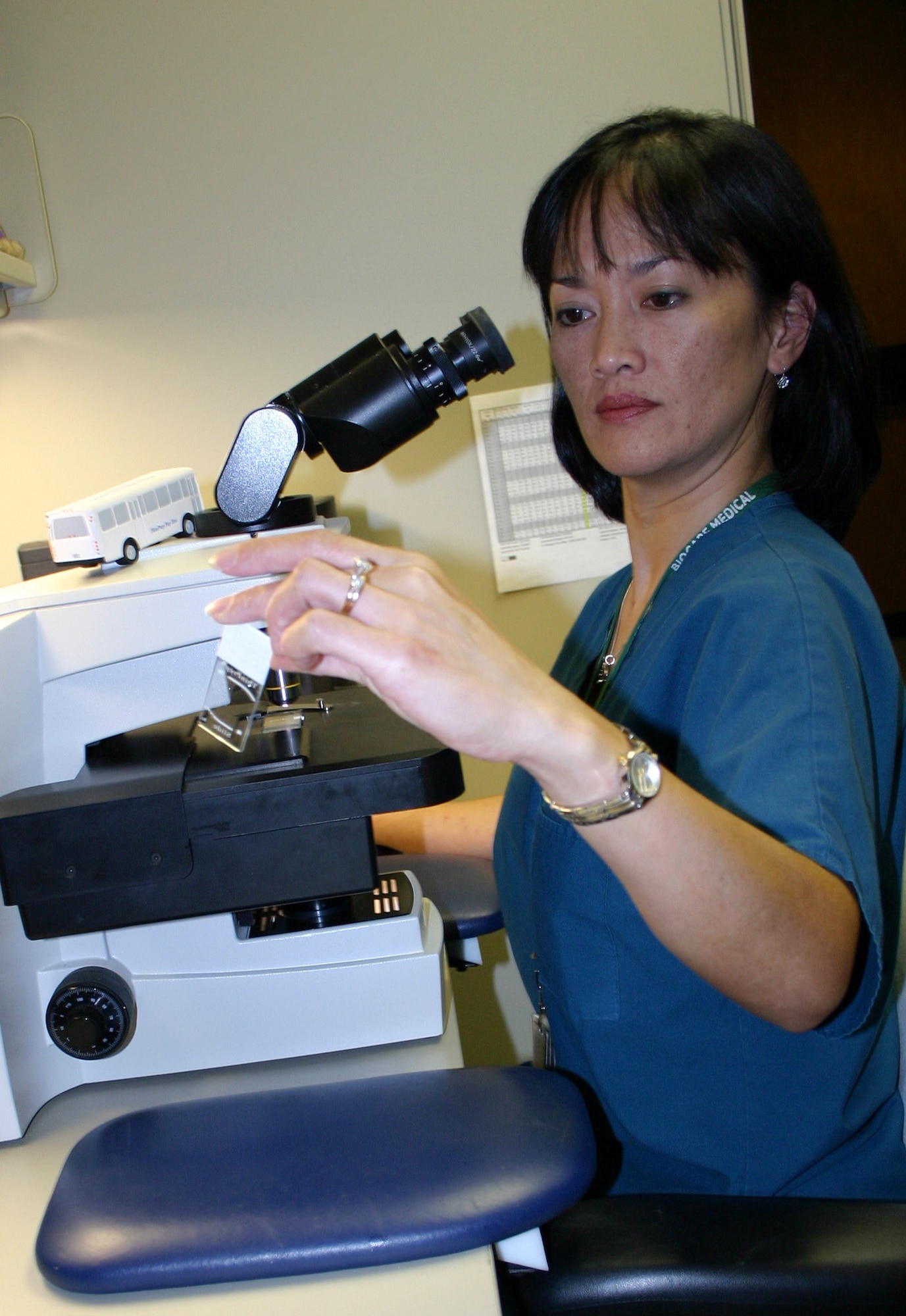 LACKLAND AIR FORCE BASE, Texas (AFPN) -- Cytotechnologist Arlene Murphy views a cytology slide on the computer-assisted microscope. The new enhanced program combines the power of computer-assisted primary screening with human expertise, allowing the Cytology Center to go from reading 75,000 slides annually to 215,000, with an increase in diagnostic confidence, sensitivity and productivity. (U.S. Air Force photo by Master Sgt. Kimberly Spencer)
