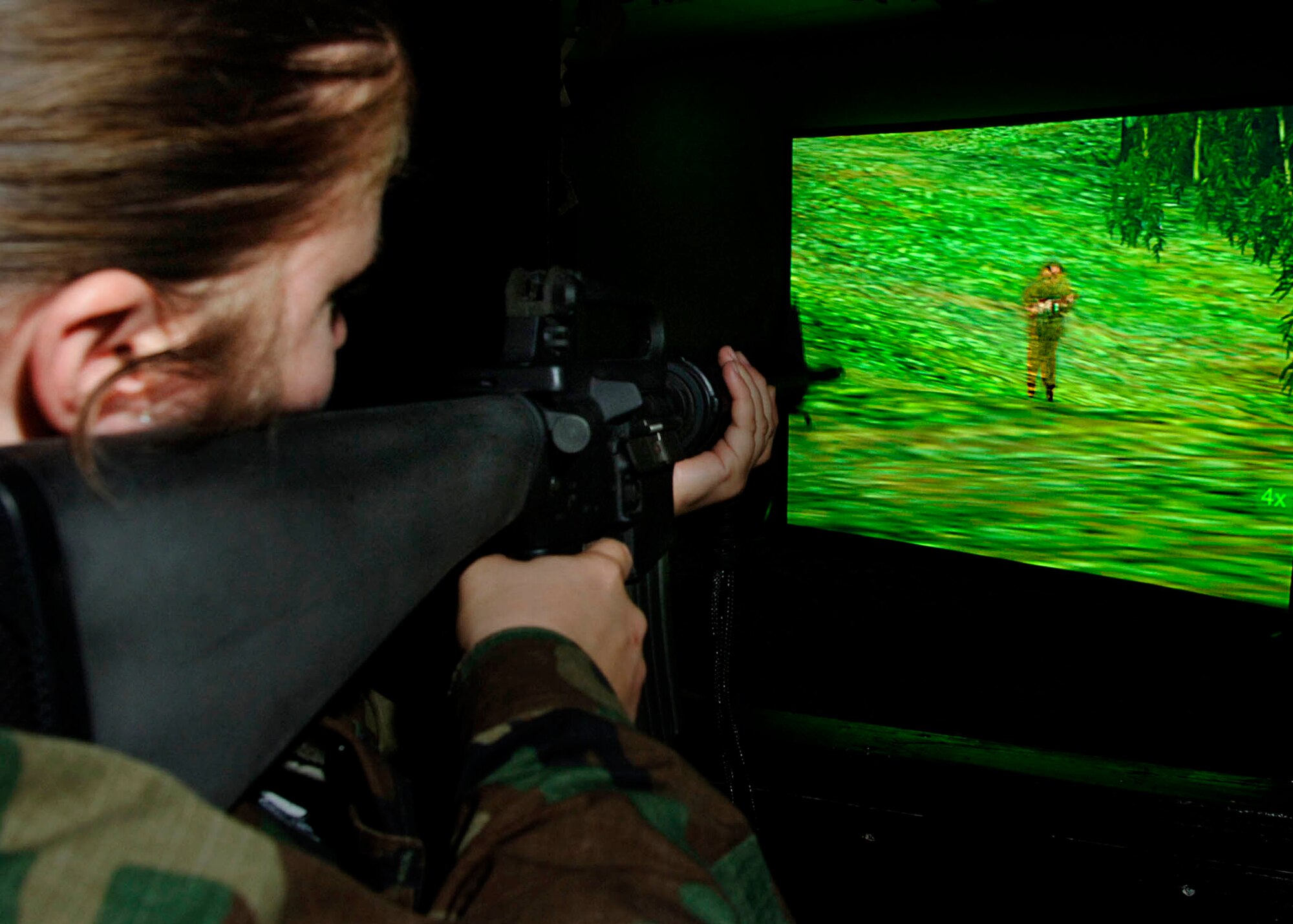 LOS ANGELES AIR FORCE BASE, Calif. (AFPN) -- Capt. Jessica Devries secures a "suspect" on the new fire arms training system. The system projects videos and computer-generated images on screen to similate various scenarios. Captain Devries is with the 61st Security Forces Squadron. (U.S. Air Force photo by Paul Testerman)
